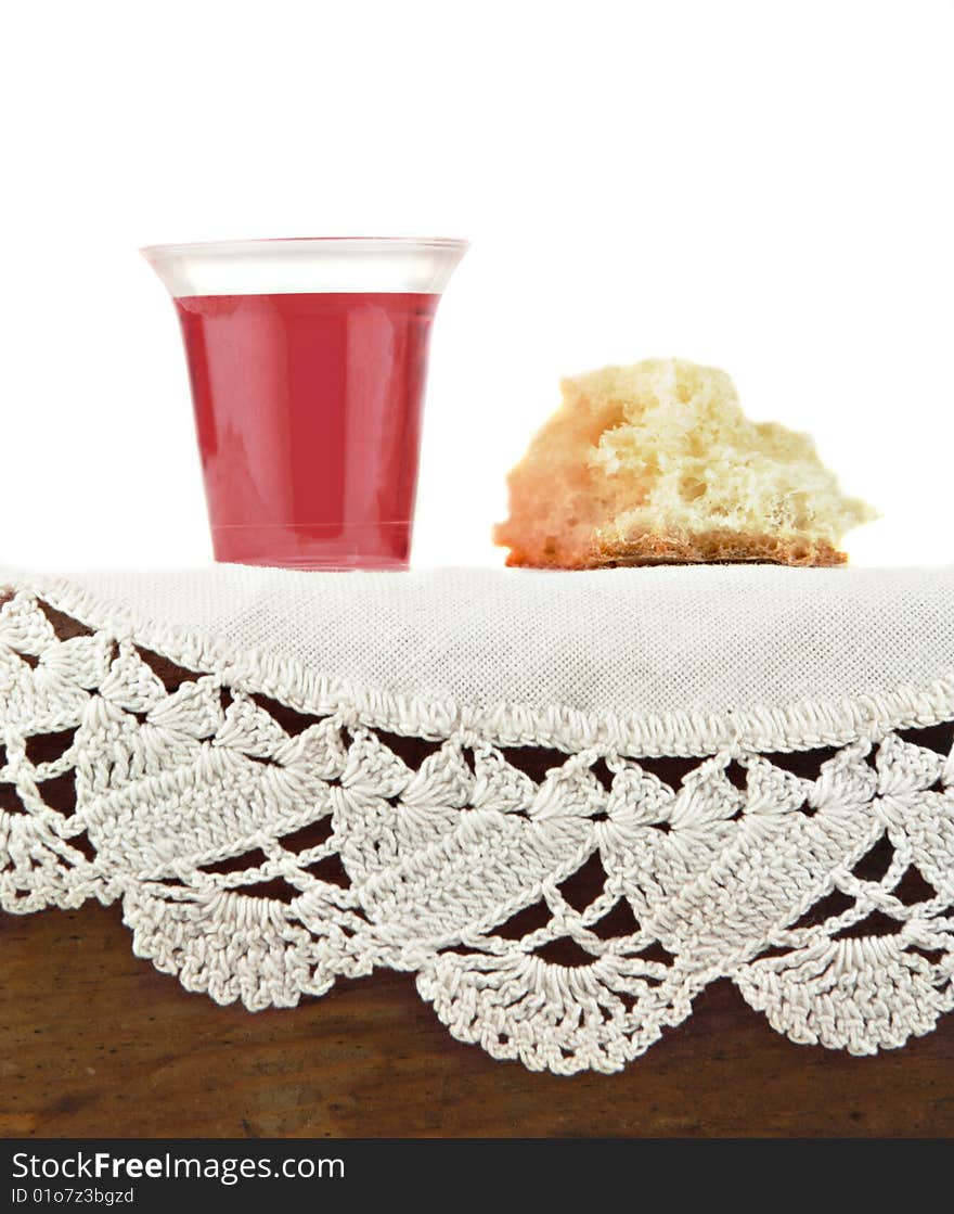 Communion bread and wine on white lace. Communion bread and wine on white lace.