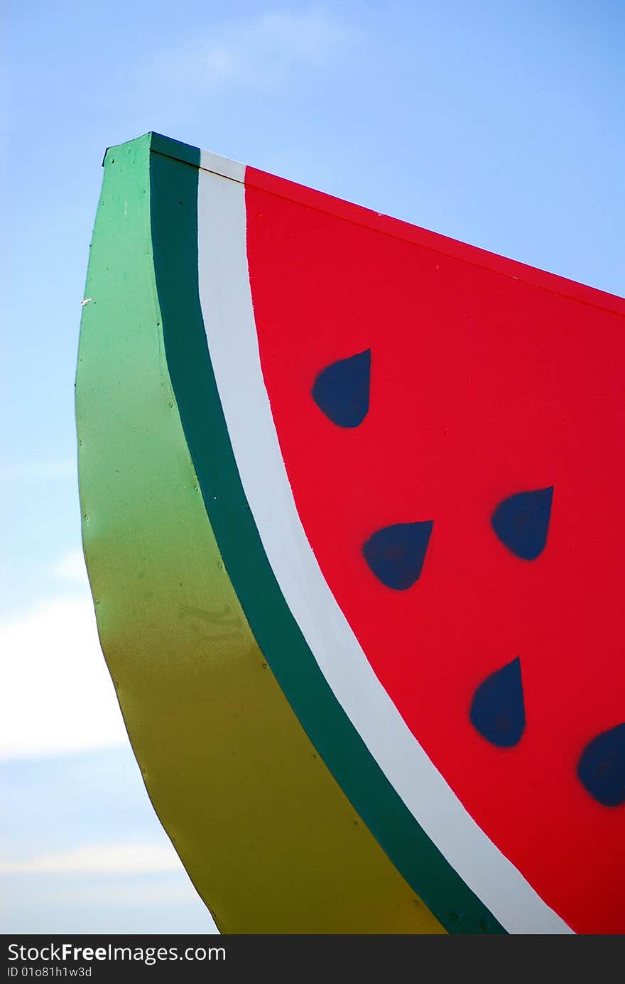 Slice of watermelon against blue sky