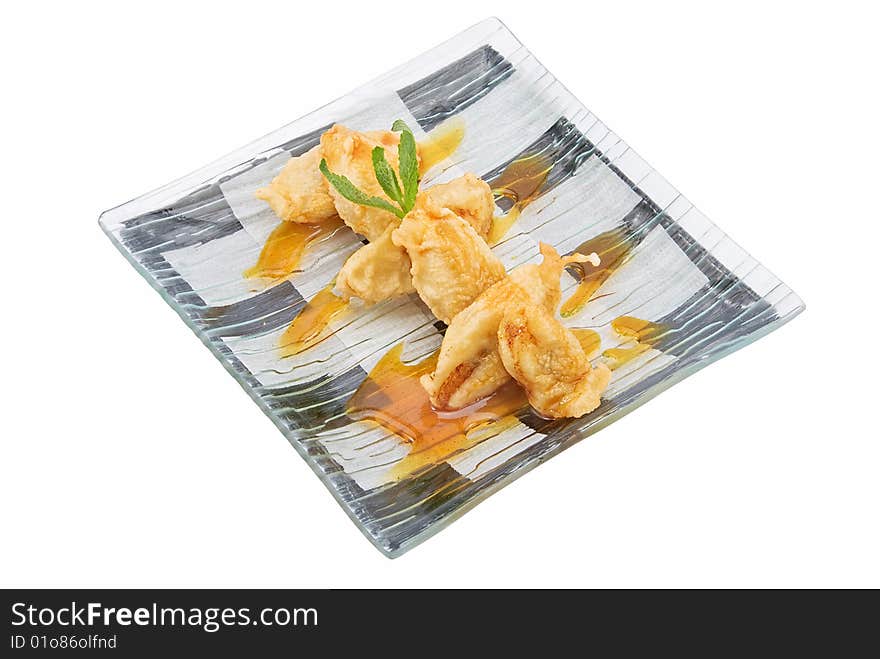 Plate with banana in tempura on white. Plate with banana in tempura on white