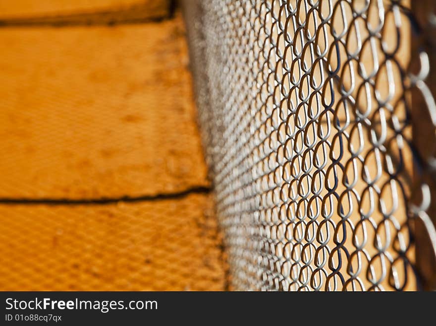 Chain link fence on a baseball field with no players in view