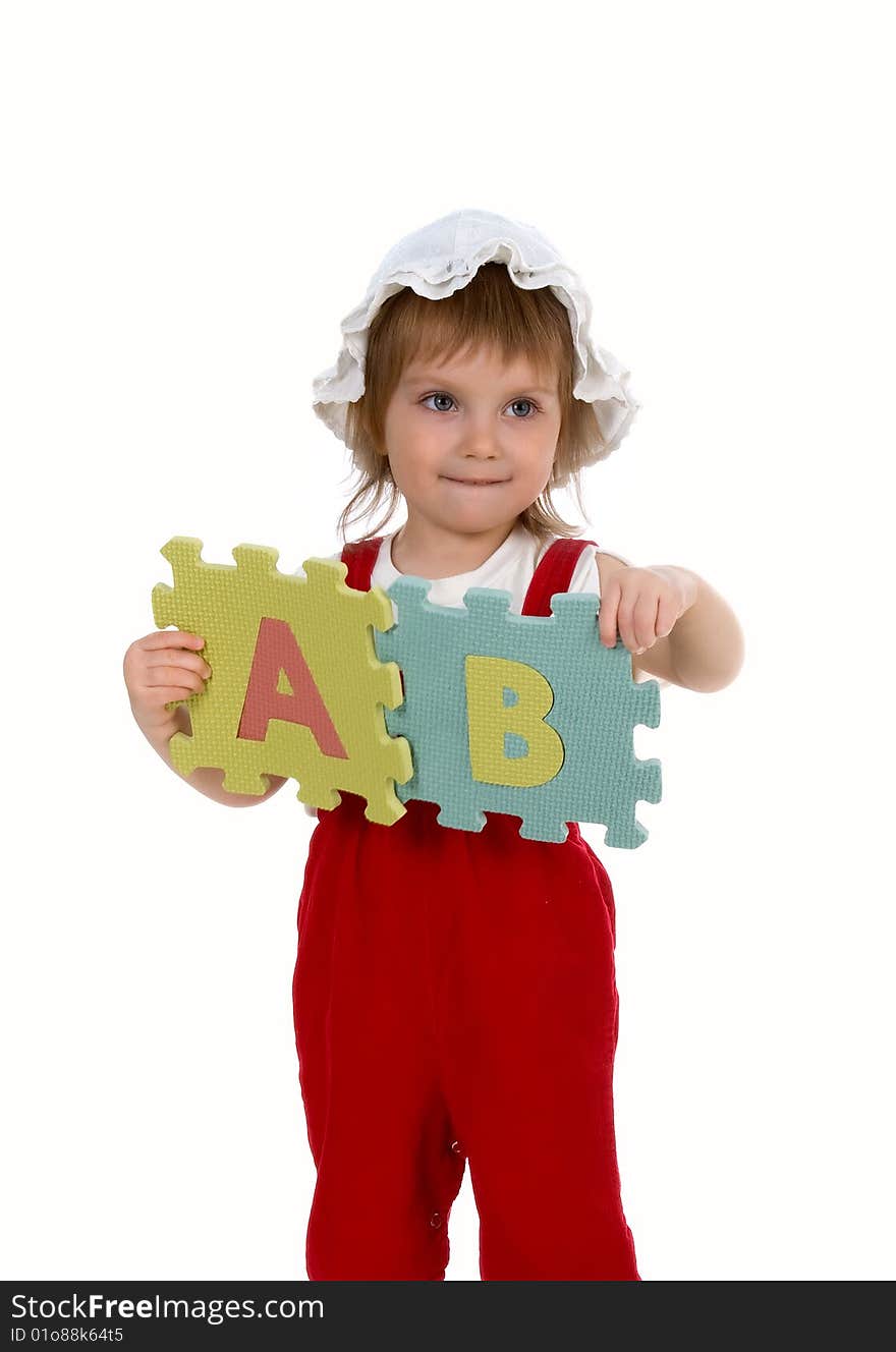 Little girl and letters on white background