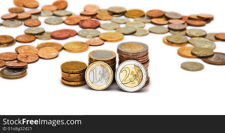 Several piles of coins isolated on white background