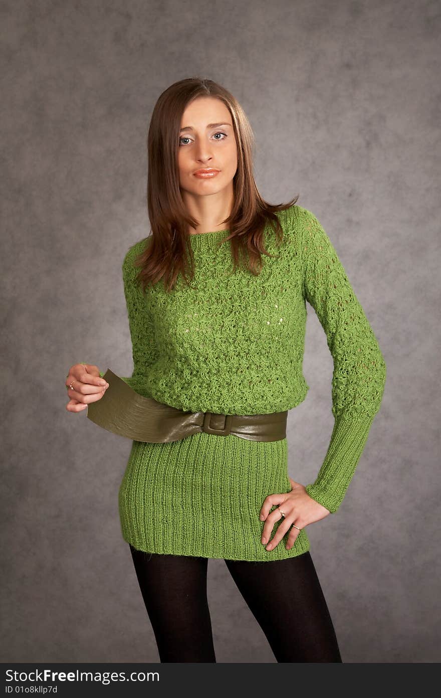 Young model possing in a studio on a grey background