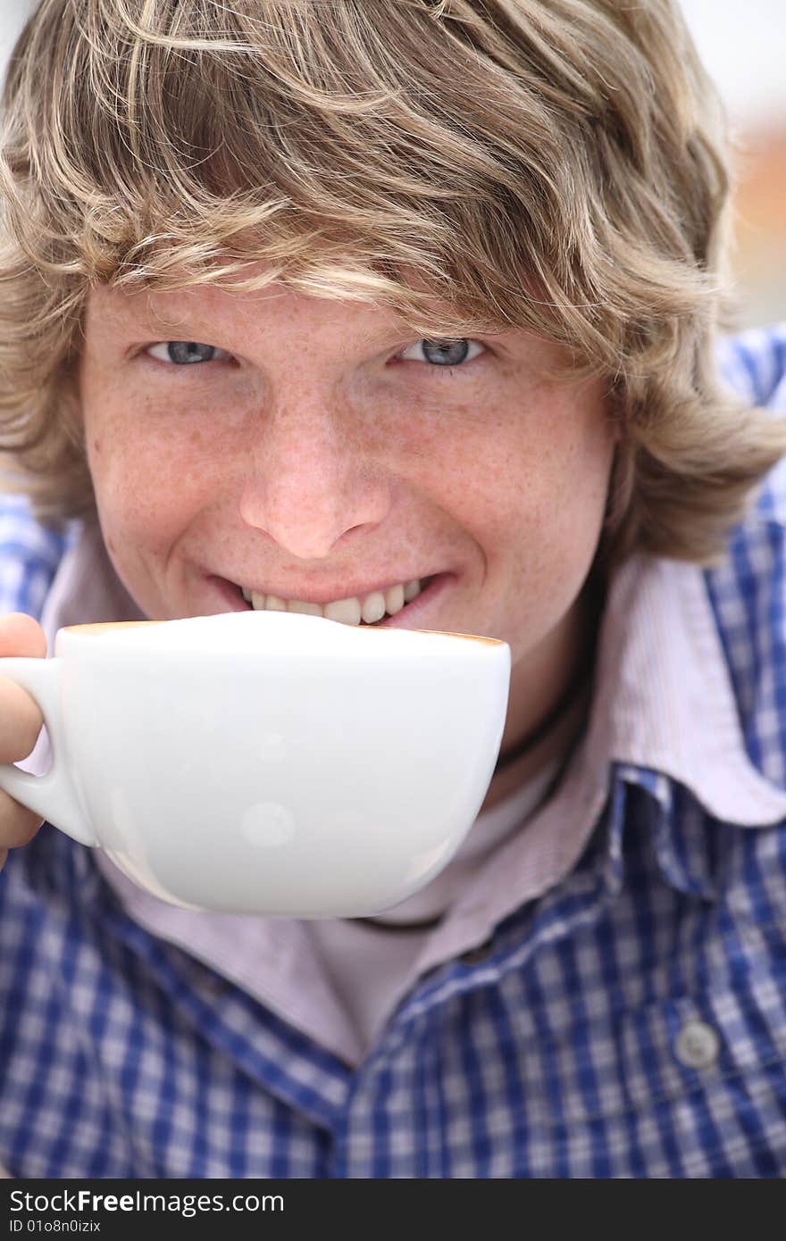 Young blond man drinking coffee. Young blond man drinking coffee