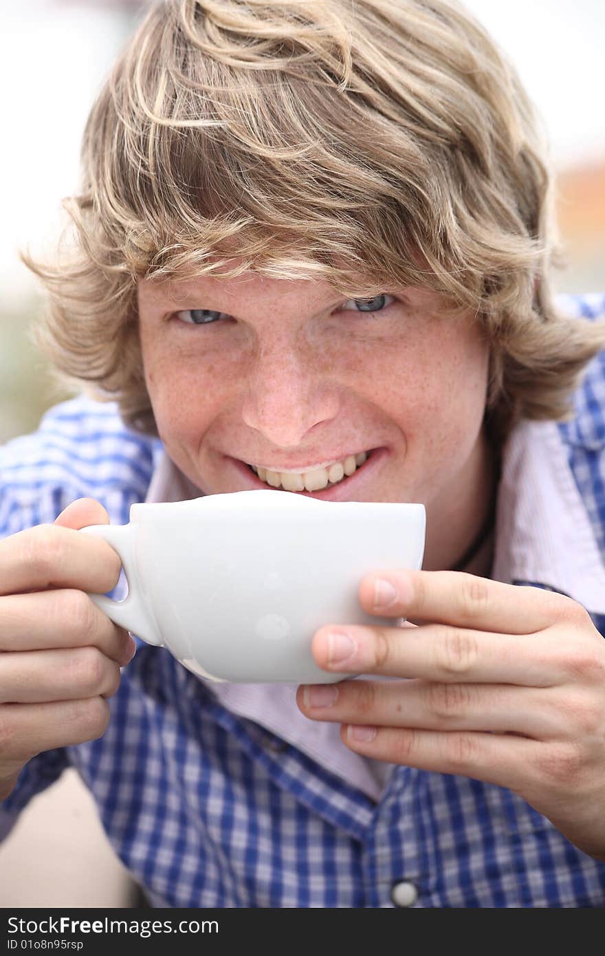 Young blond man drinking coffee. Young blond man drinking coffee