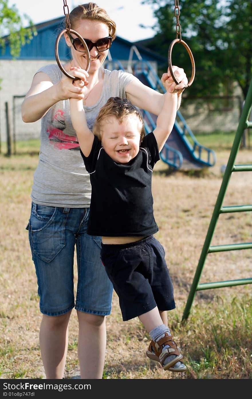 Mother and son playing on the sports ground.