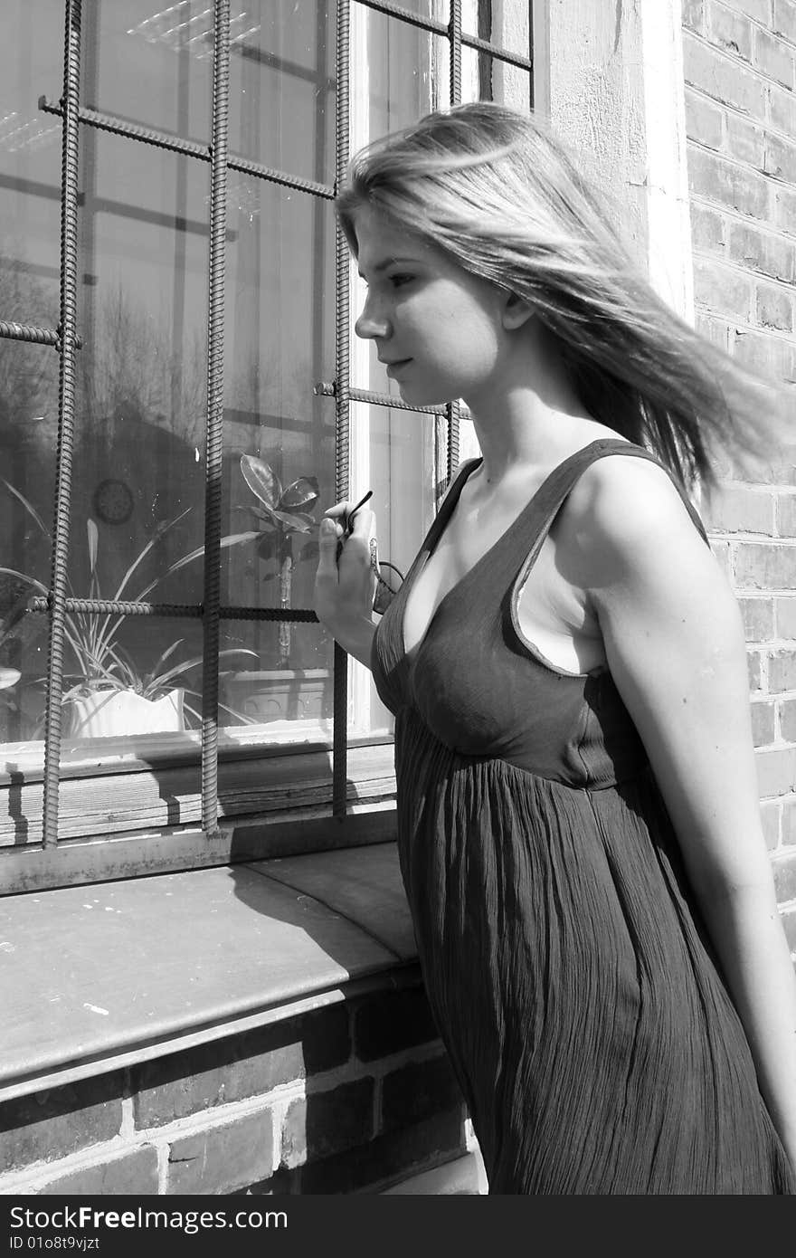 Girl standing near a window outdoors