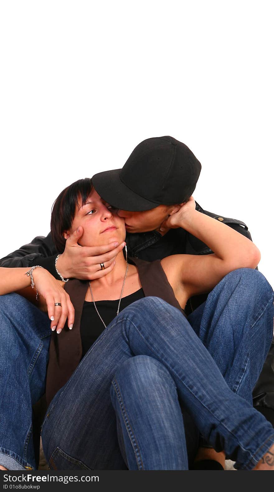 Young couple in hiphop / emo style kissing each other. Isolated over white. Young couple in hiphop / emo style kissing each other. Isolated over white.