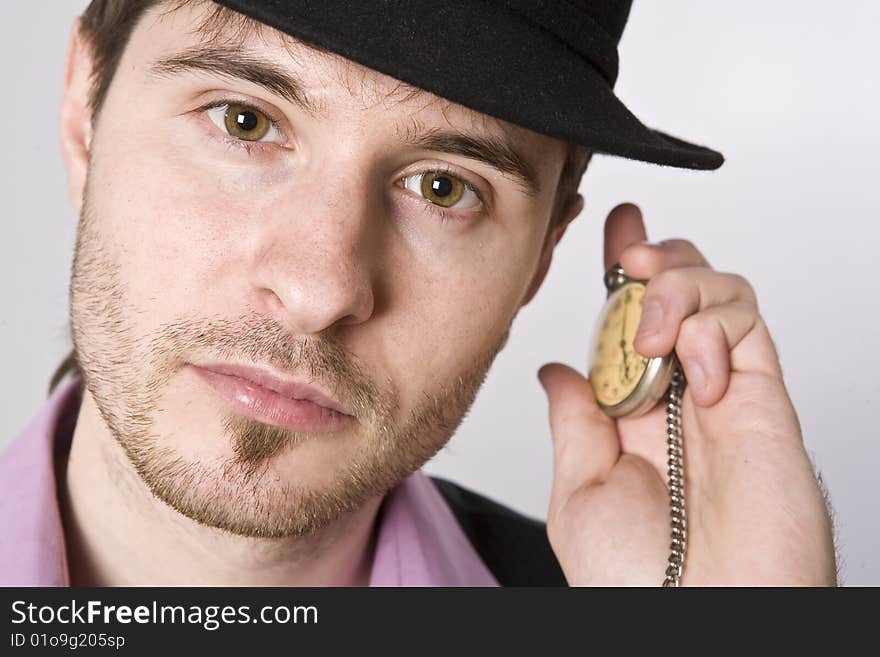 Handsome businessman holding a clock