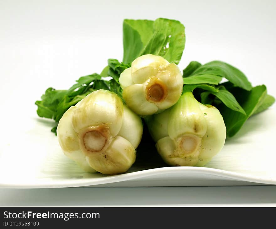 Chinese vegetable on whtie plate isolated on white background. Chinese vegetable on whtie plate isolated on white background.