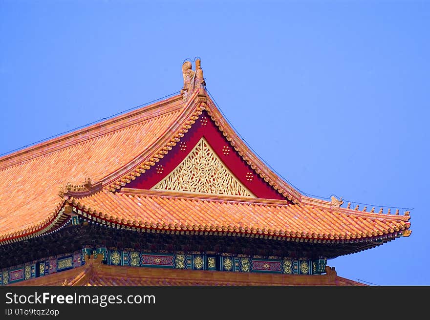 Lion statue by the forbidden city building.Lying at the center of beijing, the forbidden city, called gu gong, in chinese, was the imperial palace during the ming and qing dynasties.