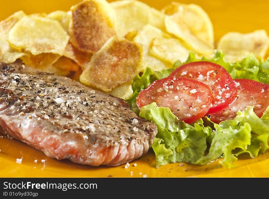 Juicy beef steak with chips and salad. Juicy beef steak with chips and salad