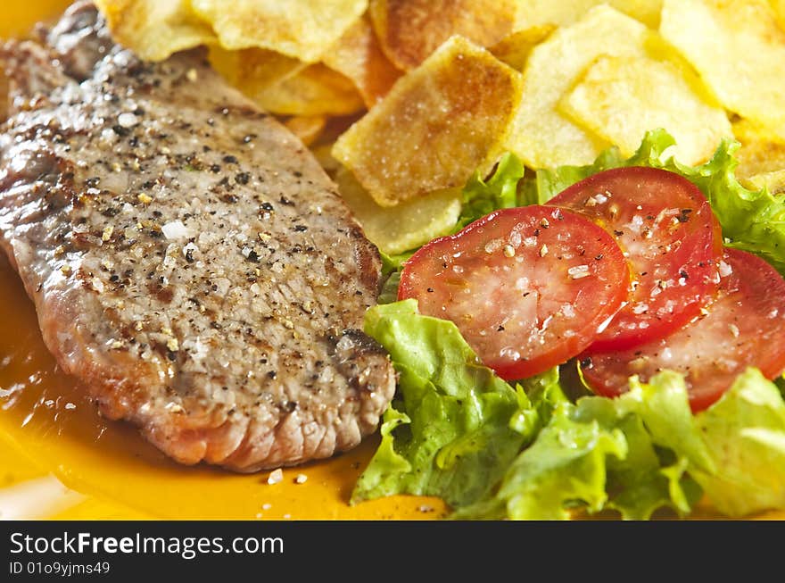 Juicy beef steak with chips and salad. Juicy beef steak with chips and salad