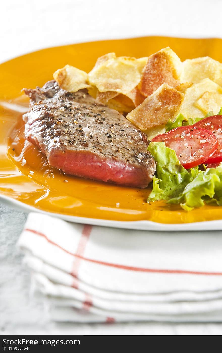 Juicy beef steak with chips and salad. Juicy beef steak with chips and salad