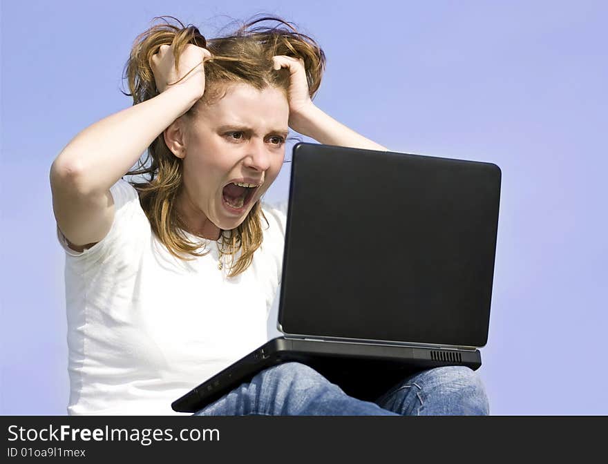 Angry surprised woman working on laptop outdoors. Angry surprised woman working on laptop outdoors