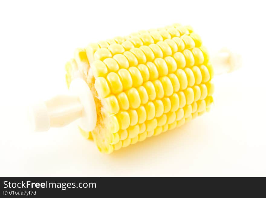 Cut section of a maize ear unwrapped and showing yellow kernels on a white background. Cut section of a maize ear unwrapped and showing yellow kernels on a white background