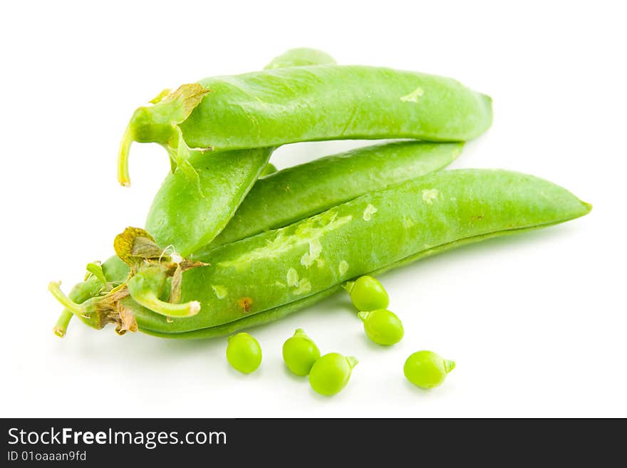 Four whole ripe peapods or english peas containing peas on a white background