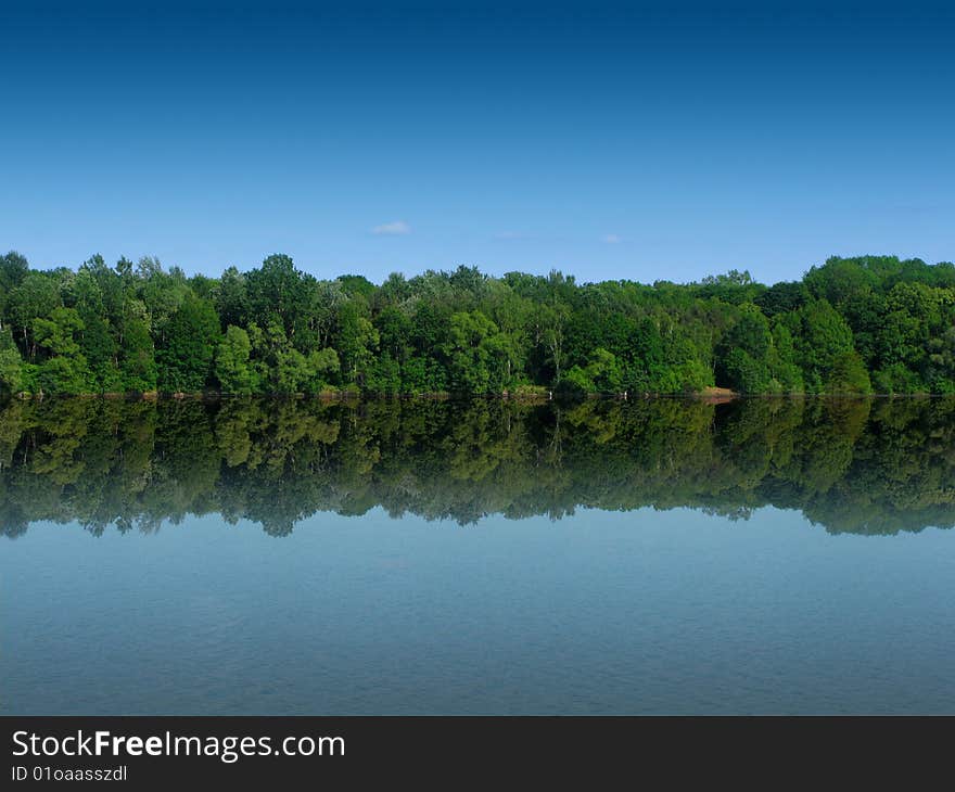 Forest landscape reflecting from the water. Forest landscape reflecting from the water