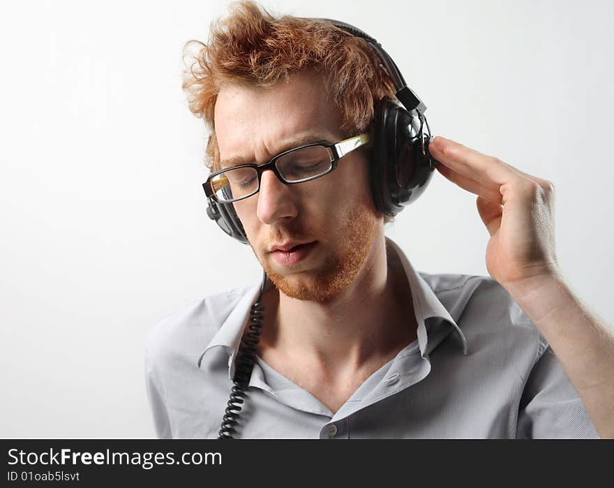 Funny guy listening music with earphones