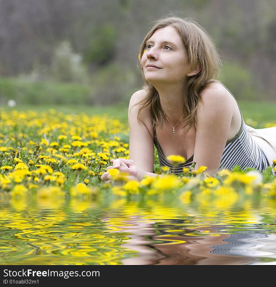 Blonde girl laying in a meadow