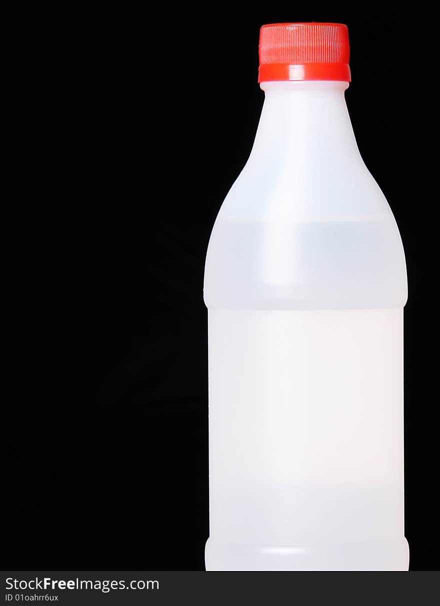 Plastic bottle on black background. Copy space