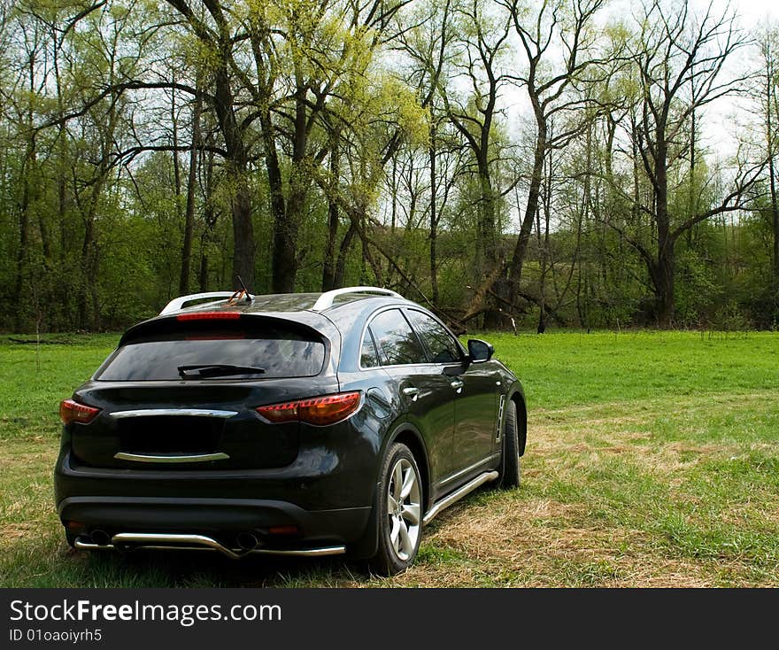 Black jeep on a wood glade. Black jeep on a wood glade