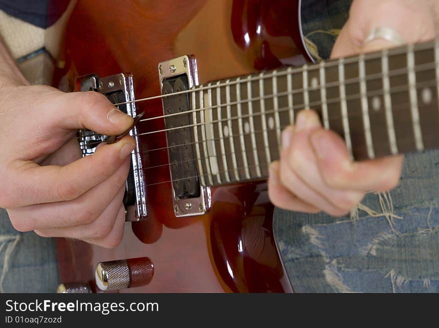 Closeup of the strings of an electric guitar