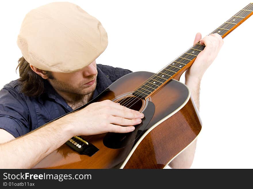 Seated guitarist playing an acoustic guitar