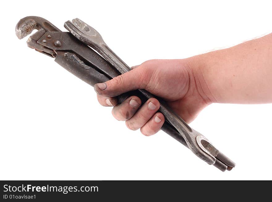 A metallic wrench is in a hand