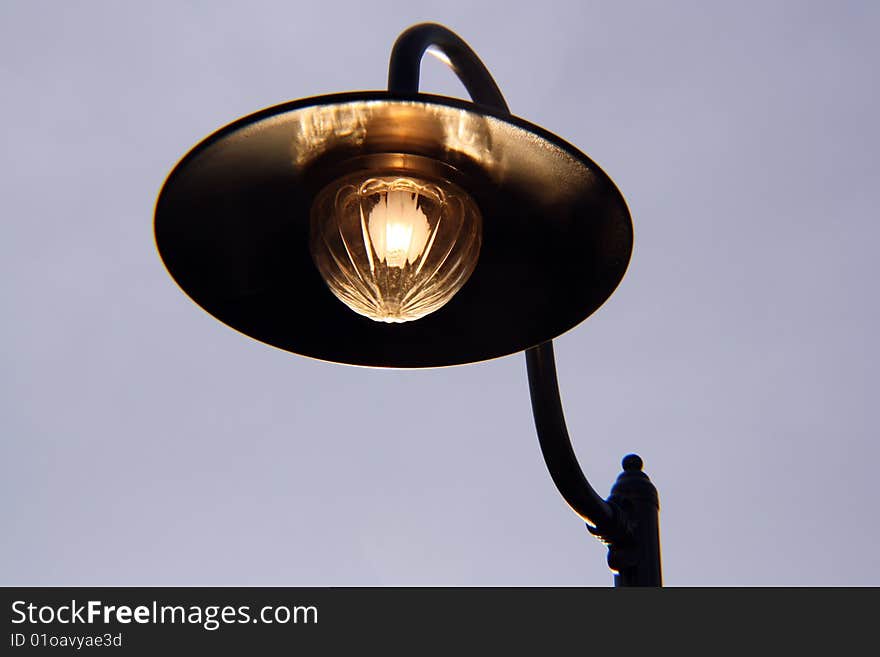 Street lamp lights at dusk