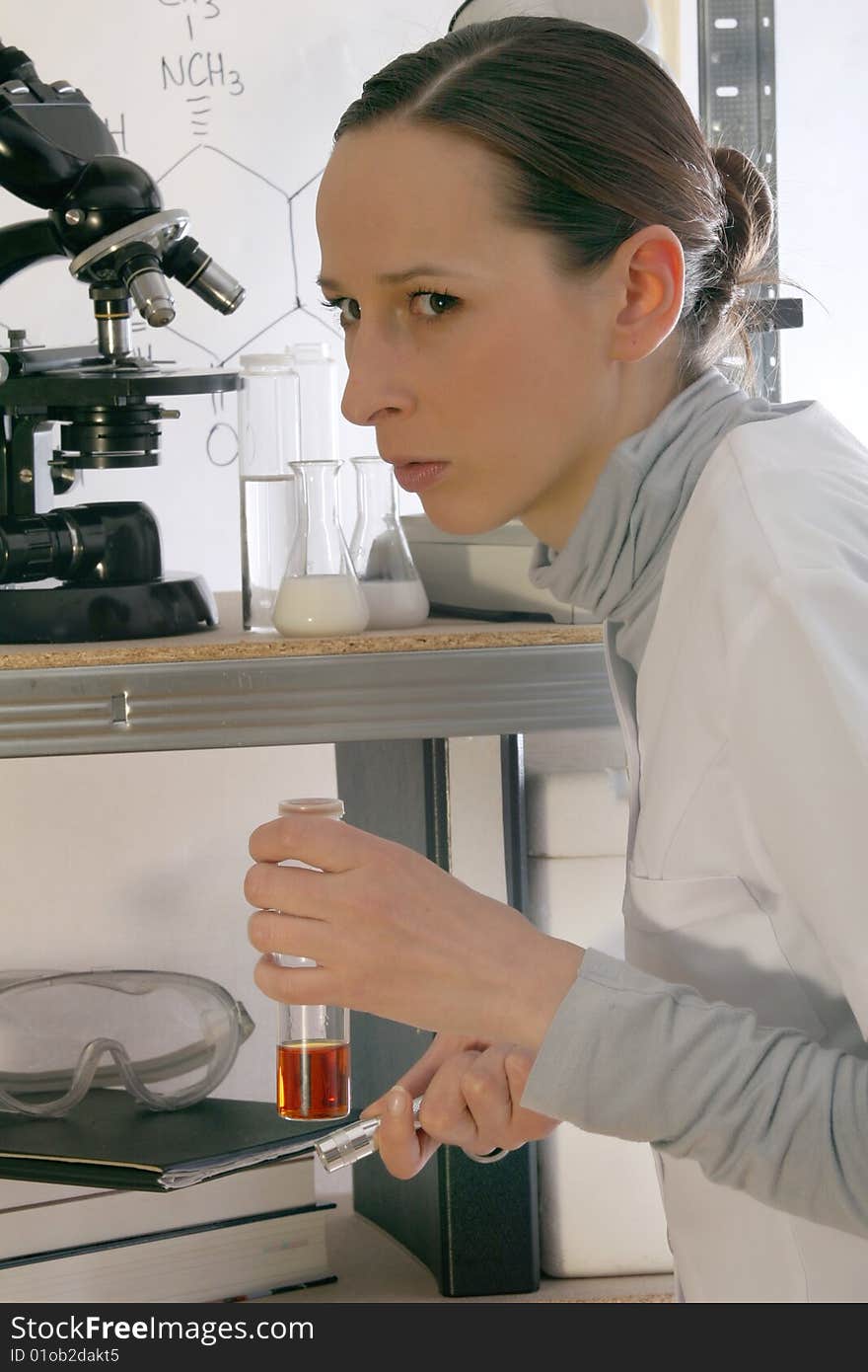 Surprised chemist with a flask in laboratory