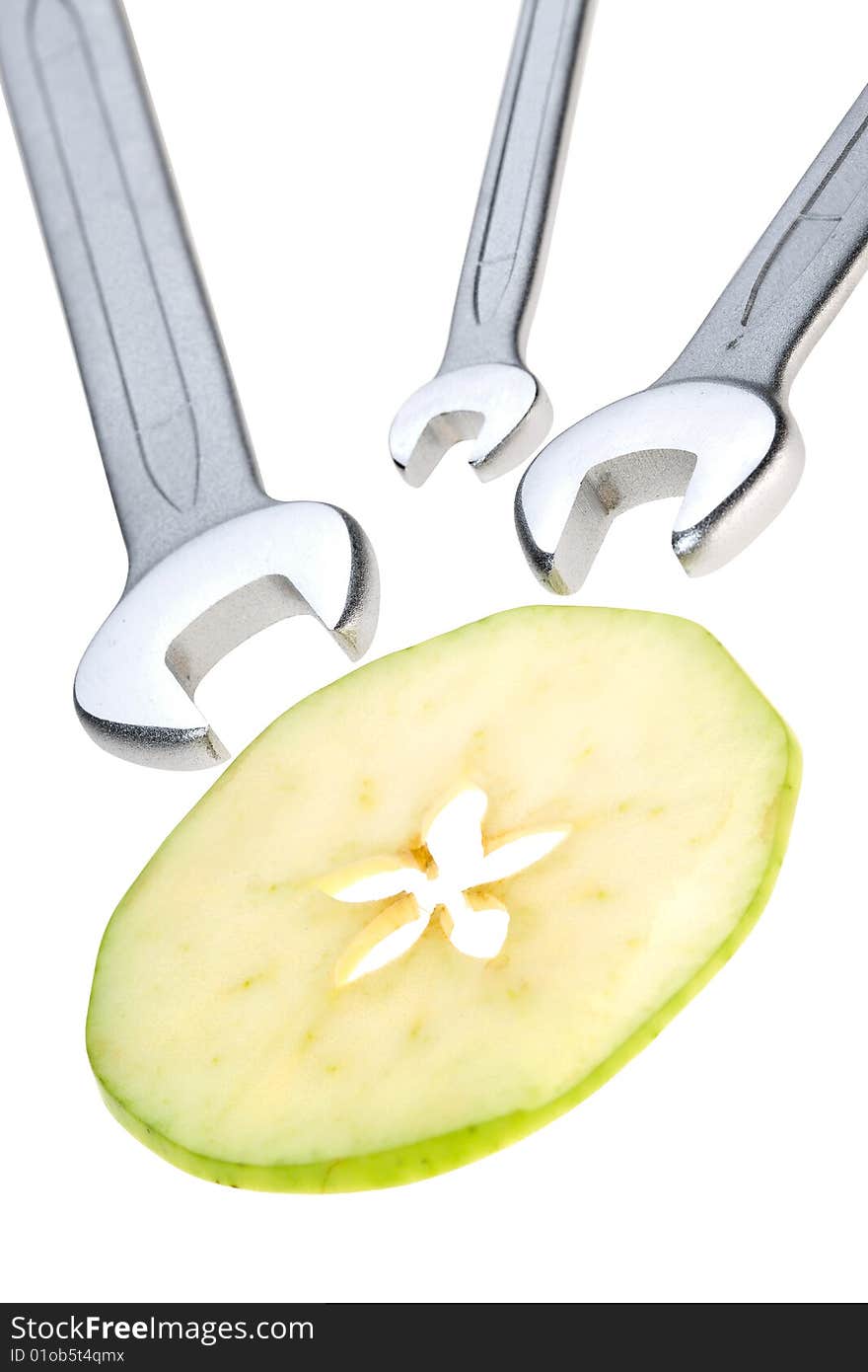 Cut apple and wrench isolated. Clipping path. Cut apple and wrench isolated. Clipping path