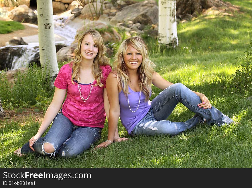 Two teenage girls posing for a portrait in scenic area