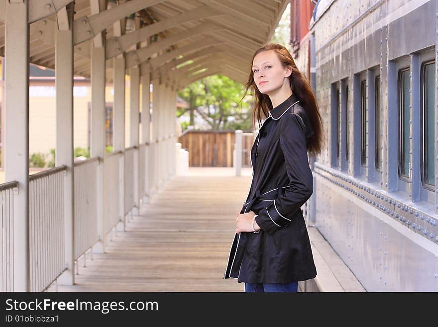 Woman standing next to train