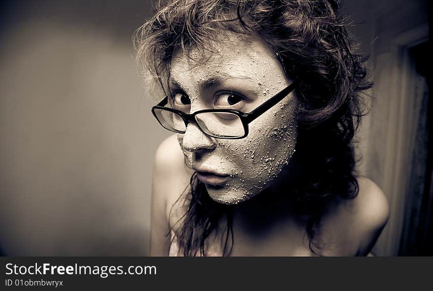 Close-up portrait of funny girl with facial mask.