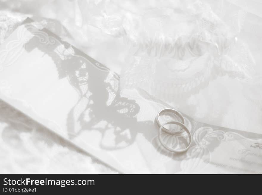 Black-and-white photo of wedding rings in an environment of laces. Black-and-white photo of wedding rings in an environment of laces