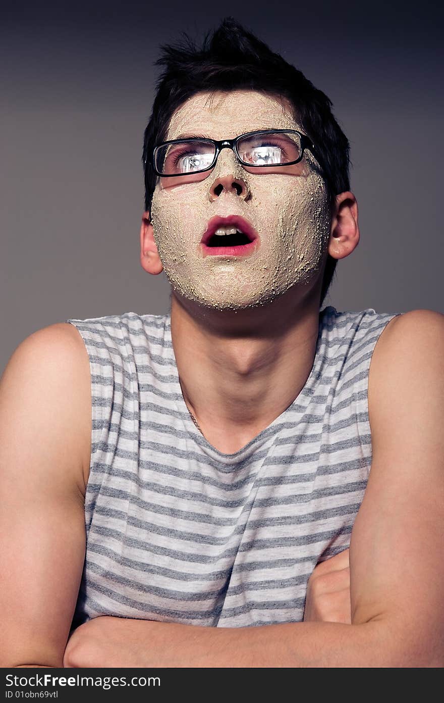 Close-up portrait of funny man with facial mask and glasses