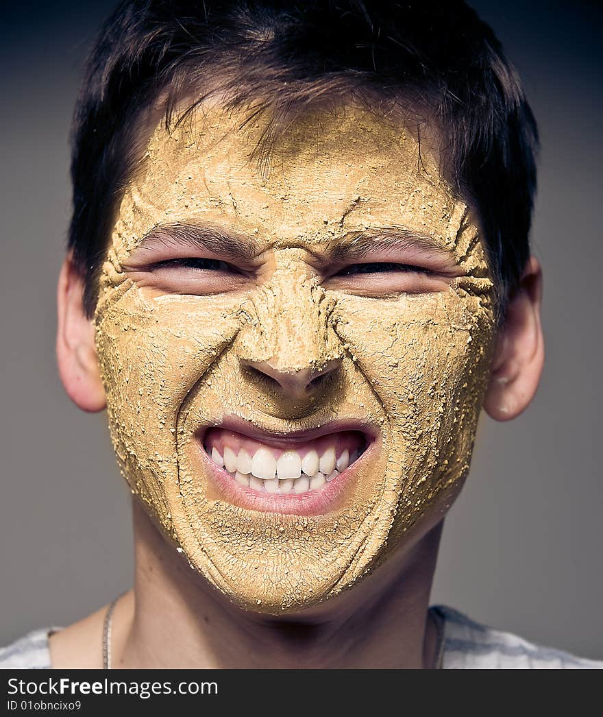 Close-up portrait of funny man with facial mask and glasses