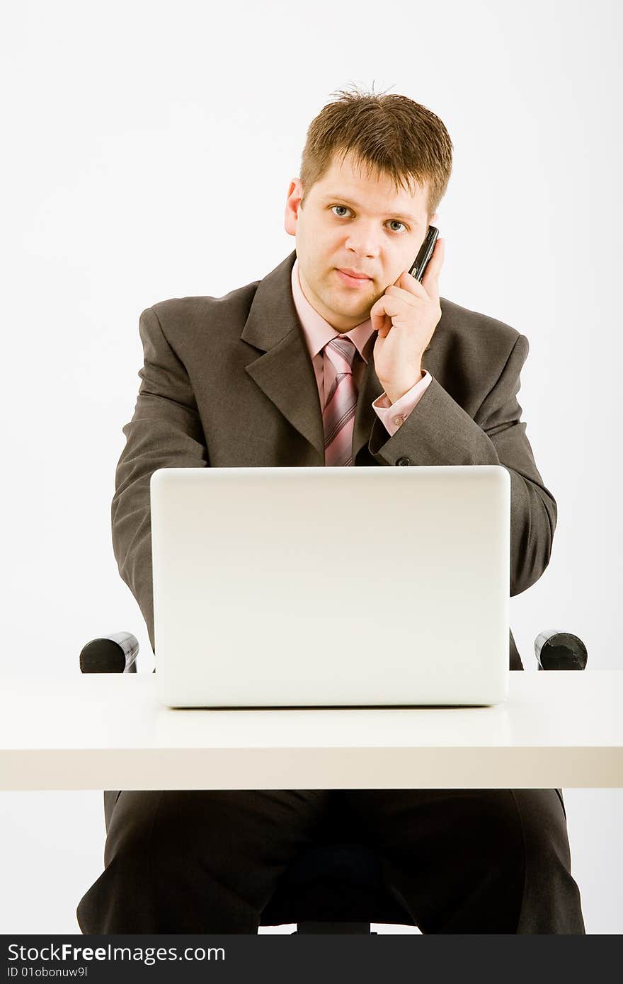 Young businessman working with phone and laptop computer