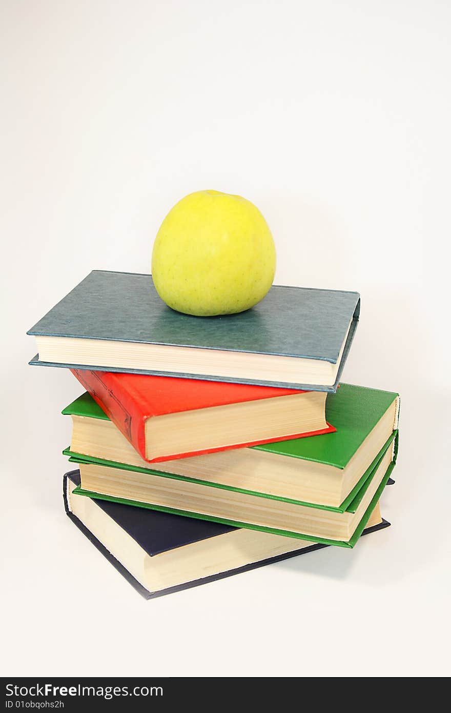 Red apple on a pile of books