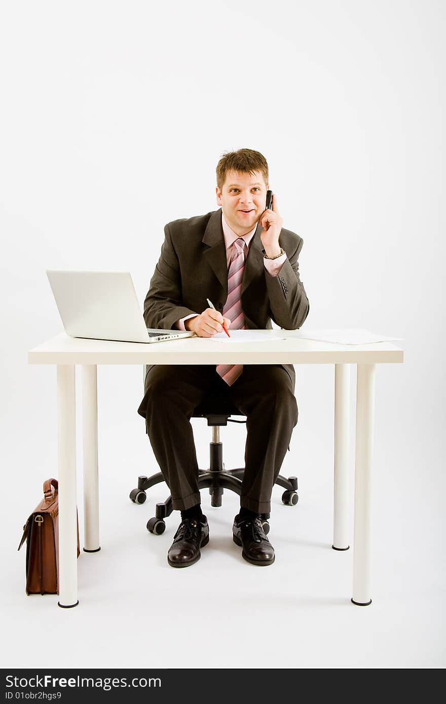 Young businessman working with phone and laptop computer