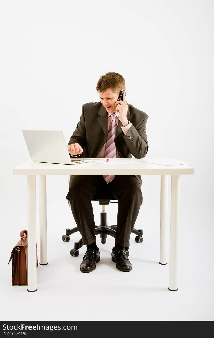 Young businessman working with phone and laptop computer