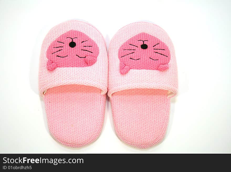 Funny pink slippers on the white background. Funny pink slippers on the white background