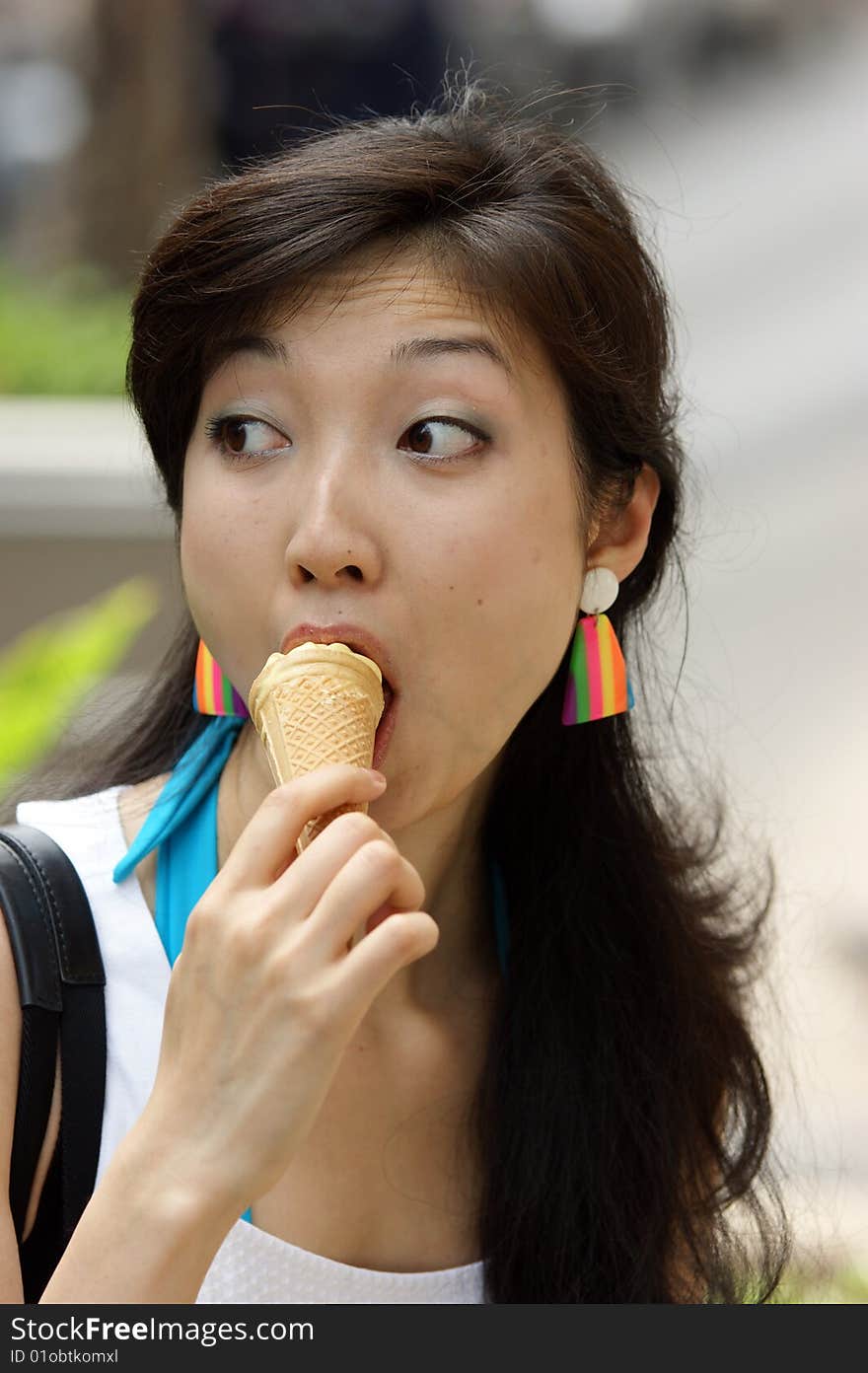 A Portrait of a young Asian woman eating ice cream