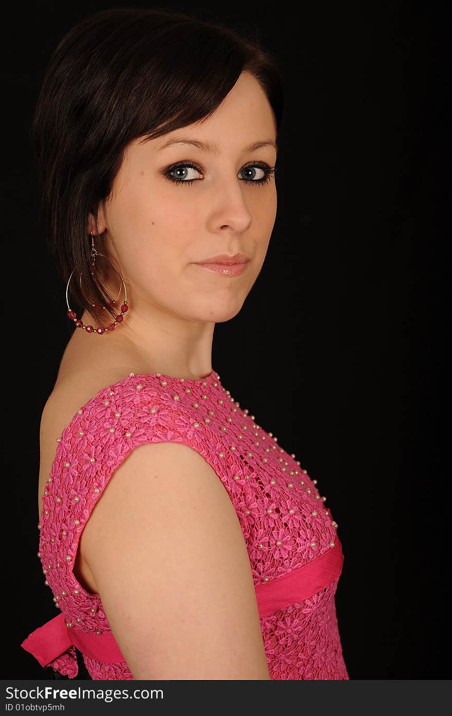 Horizontal closeup portrait of a smiling young woman, isolated against a black background. Horizontal closeup portrait of a smiling young woman, isolated against a black background.