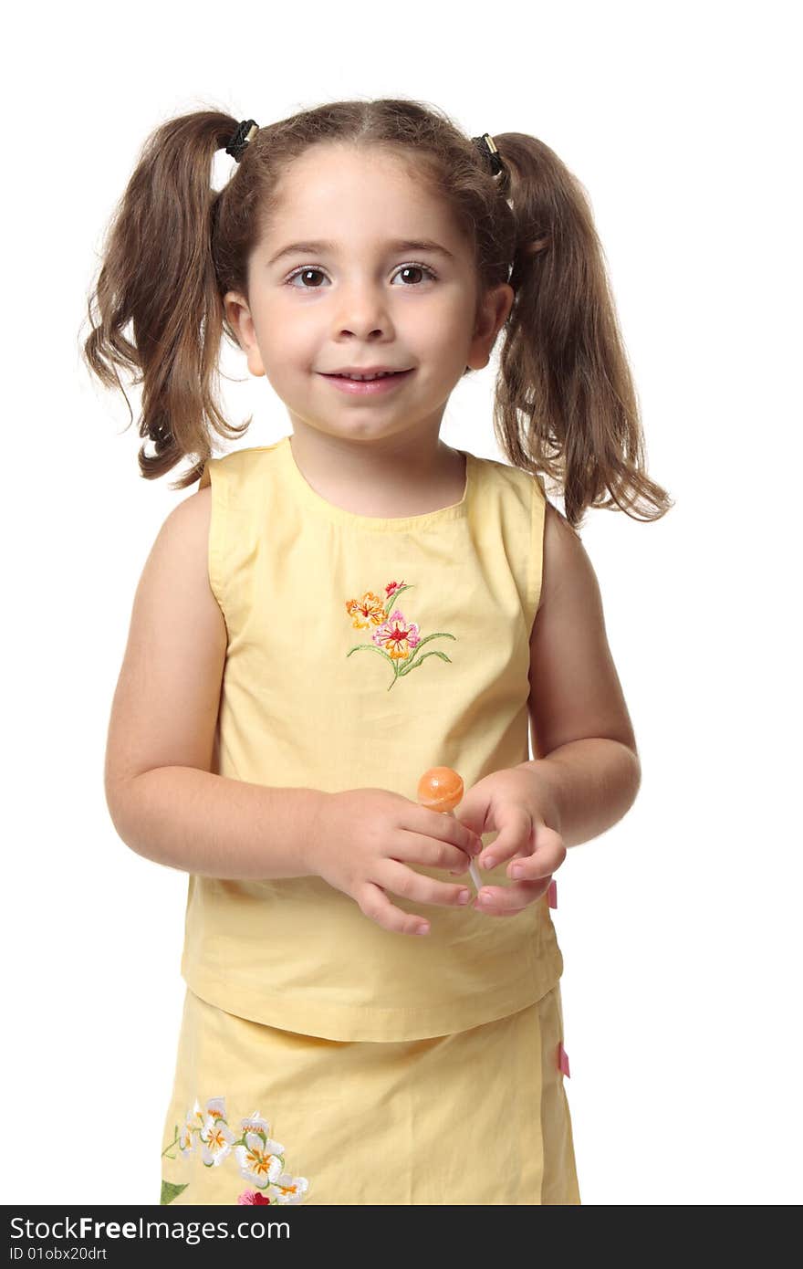 Pretty young toddler girl holding a sweet lollipop and smiling. Pretty young toddler girl holding a sweet lollipop and smiling.