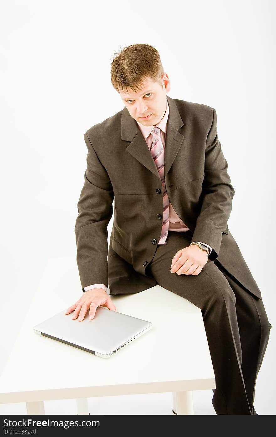 Young business man with laptop computer on white background