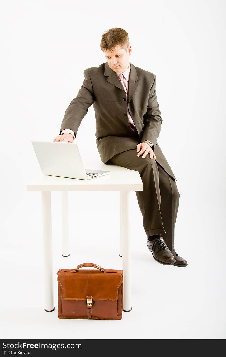 Young business man with laptop computer on white background