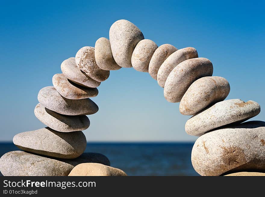 Arch  of white pebbles on the sea coast. Arch  of white pebbles on the sea coast