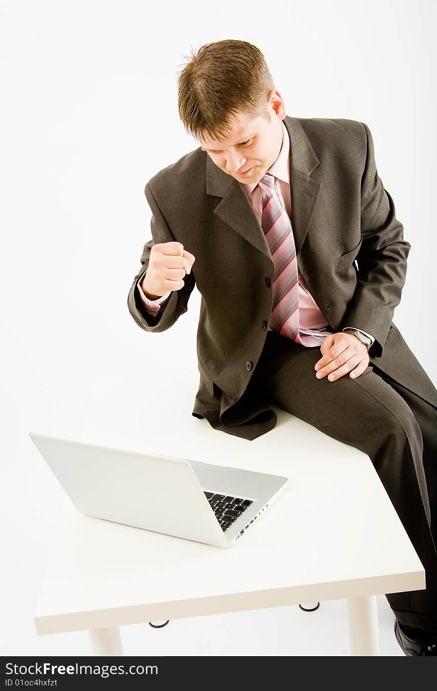 Young business man with laptop computer on white background